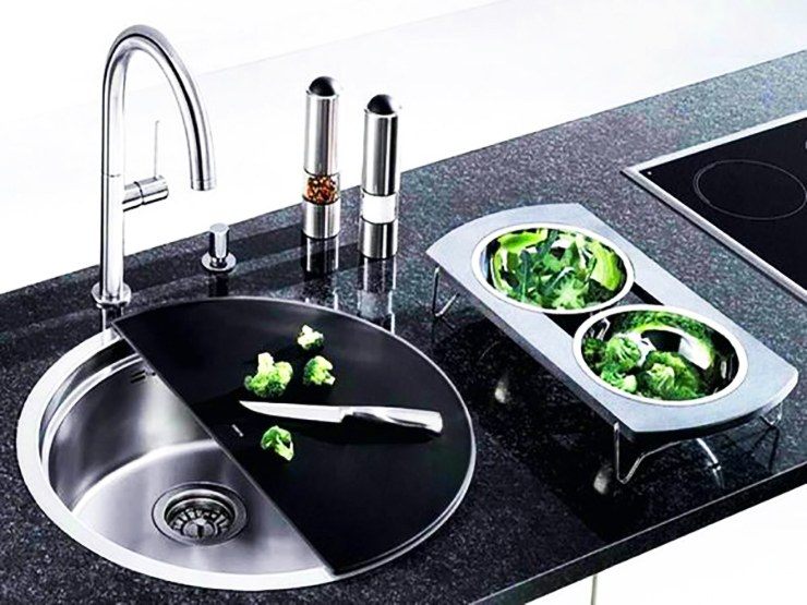 black circular kitchen sink with cutting tray