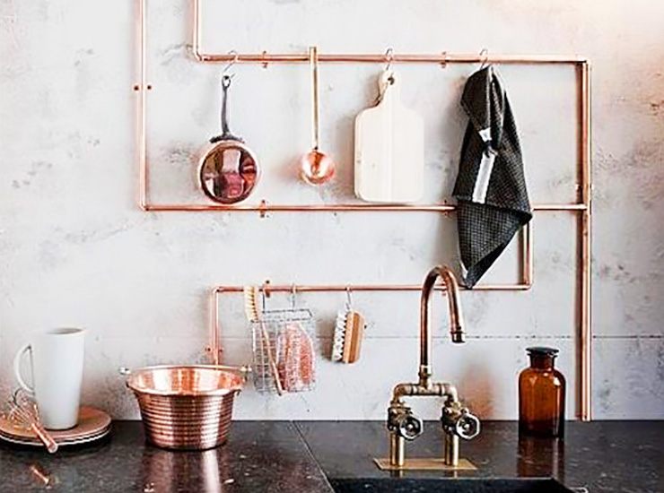 hanging items on kitchen pipes to hide them and make them functional