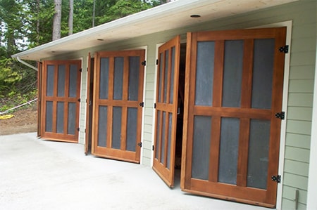 carriage garage doors open up from the center and swing outwards to either side