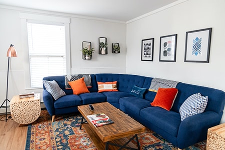 one of the best ways to make a living room cozy is to have a giant sectional sofa that your guests can sprawl out on