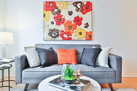 Having two subdued colors in your room and then having attention-drawing items be a much brighter color is a great and cozy way of decorating your living room