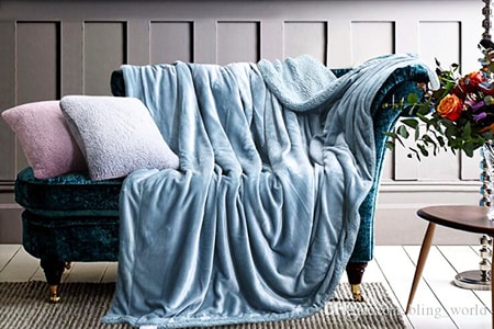 colorful throw blankets in the living room help guests feel comfy, playful, and cozy, especially in the colder months