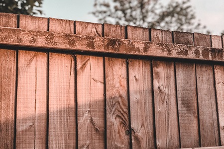 one of the cheapest wooden fence styles are wood dog-ear fence
