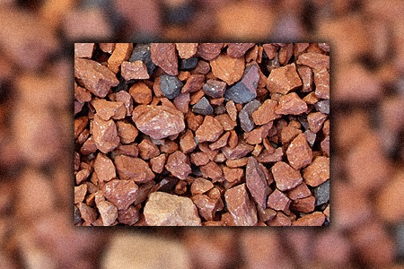 if you are looking for different types of landscaping rocks that are low cost, brick chips can be a good solution