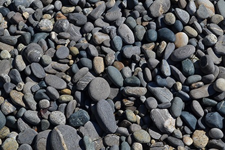 river rock is just another types of landscaping stone that can add beauty to your space with its various colors