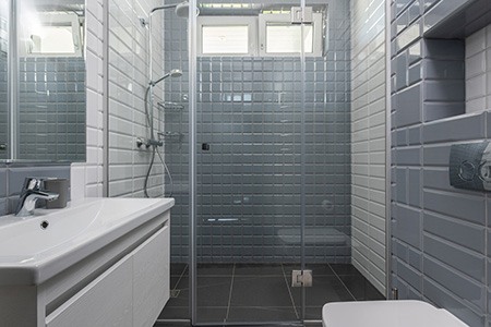 the cost range of showers without thresholds varies primarily on the design and drain cost