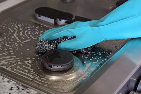 using abrasive cleaning pads, steel brushes, or steel wool