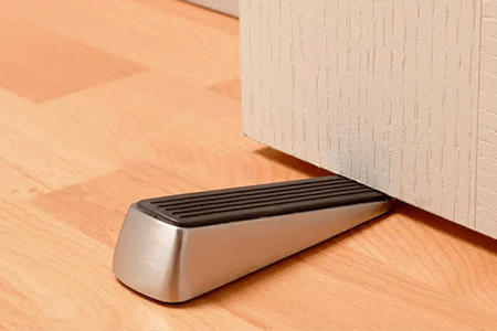 you can stop a door from closing by using a wedge door stopper