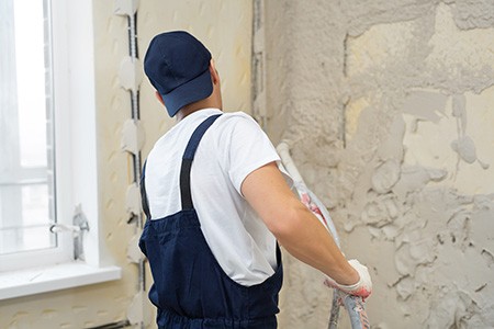 one of the steps for using stucco on a brick wall is mixing & applying stucco