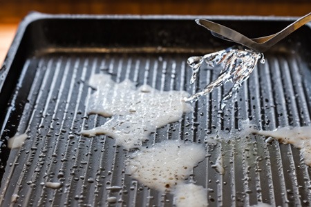 add water to the soiled areas of the griddle