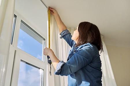 you must consider the height of the curtain rod while hanging curtains over an arched window